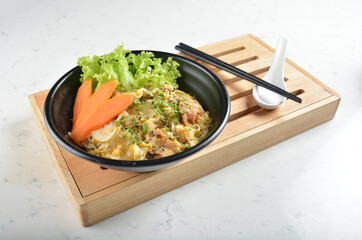 japanese oyakodon chicken rice bowl with salad in black bowl in white marble healthy poke bowl menu