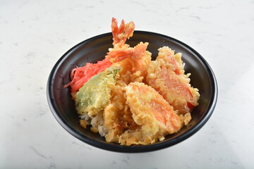japanese deep fried tempura prawn and vegetables rice bowl in black bowl in white marble healthy...