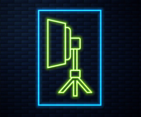 Glowing neon line Studio light bulb in softbox icon isolated on brick wall background. Shadow reflection design. Vector