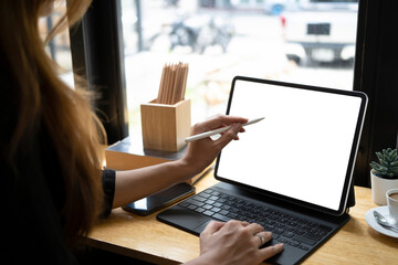 Close up view woman holding stylus pen pointing on screen of computer tablet.