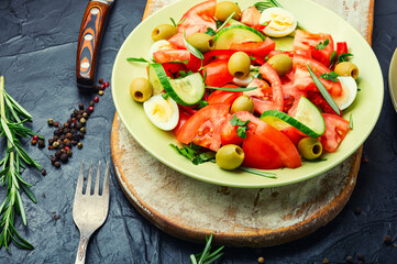 Salad with vegetables, olives, eggs and rosemary