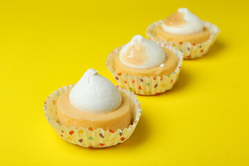 Lemon cupcakes on yellow background, close up