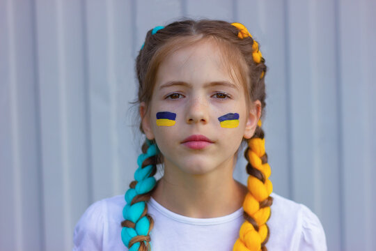 portrait of a proud Ukrainian girl with blue and yellow hair. sport and fans support concept. patriotism and independence of Ukraine.