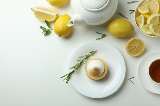 Concept of tasty breakfast with lemon cupcake on white background