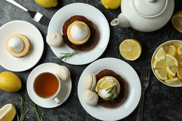 Concept of tasty breakfast with lemon cupcakes and macaroons