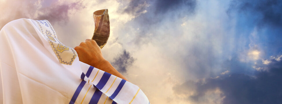 Jewish man blowing the Shofar (horn) of Rosh Hashanah (New Year). Religious symbol