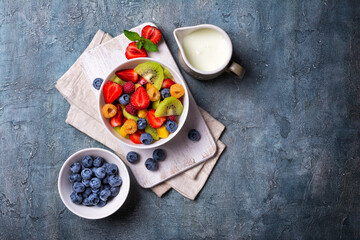Bowl of healthy salad with fresh fruits, berries and yogurt