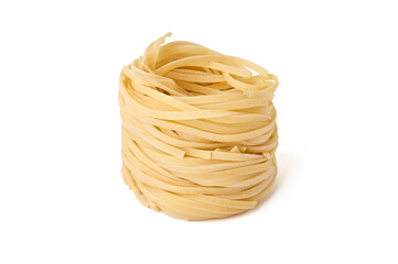 Uncooked nest of fettuccine pasta isolated on white background