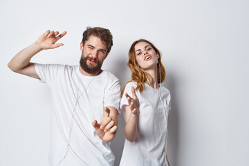 young couple in white t-shirts and jeans casual wear fun positive