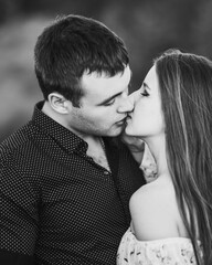 Close up sensual portrait of young kissing couple in love. Black and white