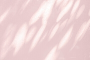 Abstract leaves shadow background pink light bokeh of tree branch on concrete wall texture.