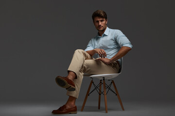 Confident european business man sitting on chair