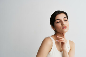 woman in white t-shirt with lotion in hands cosmetics clean skin close-up