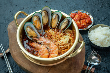jamppong, Spicy mixed-up seafood noodle soup, Korean noodle soup with red spicy seafood, rice and  kimchi.