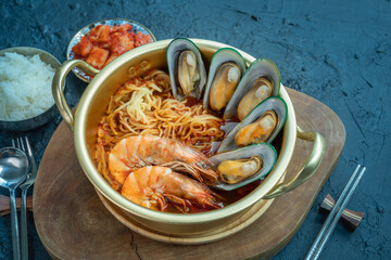 jamppong, Spicy mixed-up seafood noodle soup, Korean noodle soup with red spicy seafood, rice and  kimchi.