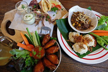 Fried sticky rice served with northern thai curry, chicken wings and Battered deep fried calamari