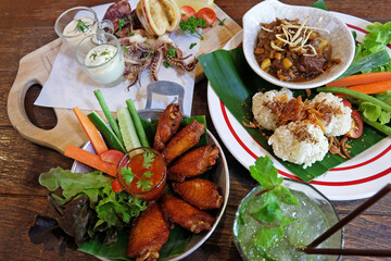 Fried sticky rice served with northern thai curry, chicken wings and Battered deep fried calamari