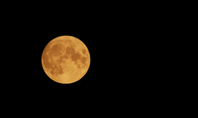 Full Orange Moon movement across the sky on July 23, 2021. Halloween Moon concept.