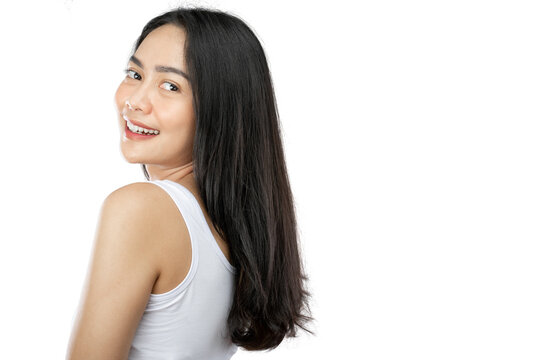 view side of attractive girl with long black hair with copy space on gray background