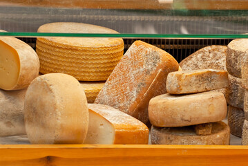 Different types of cheese on the table. Many cheese is sold at an agricultural fair. Natural home product.