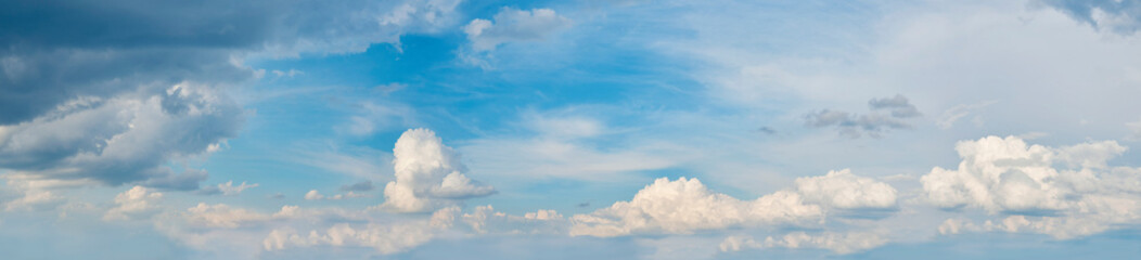 Beautiful blue cloudy sky. A panoramic composition in high resolution.