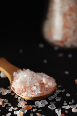 A wooden spoon with pink Himalayan salt