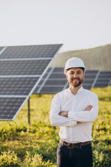Young architect standing by solar panels