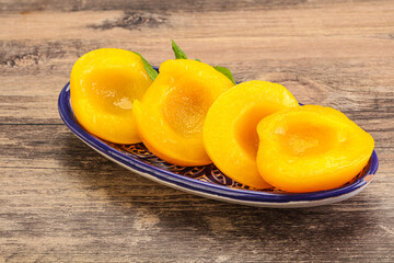 Sweet ripe canned peaches with mint