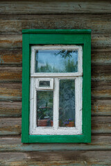 A beautiful old window in a carved wooden frame