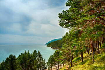 Fototapeta premium A beautiful natural landscape with a lake, shore and rocks in summer, warm sunny weather.