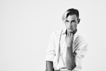 cheerful men in white shirt sitting on a chair posing fashion modern style