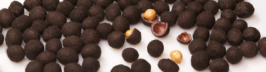 Glazed peanuts in sweet shell with cocoa on white