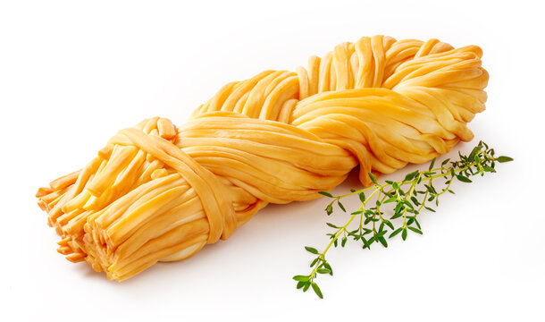 Chechil cheese with thyme isolated. Smoke chechil cheese on white background. Cheese braid of chechil for package design.