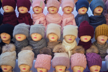 Fototapeta na wymiar Winter and autumnal warm hats on mannequins in a shop window