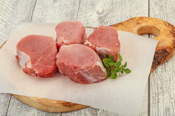 Raw pork medallion served rosemary