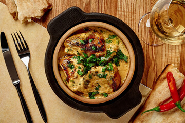 Georgian chicken Shkmeruli stewed in milk with nuts and garlic