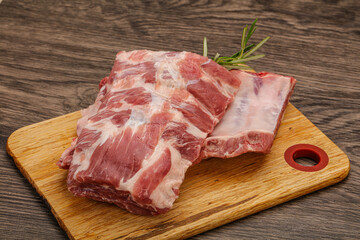 Raw pork ribs served rosemary