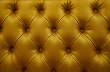 Luxurious leather soft sofa close-up. Stylish golden or brown material is decorated with  buttons....