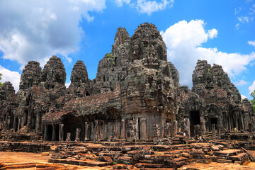 Beautiful scenic landscape with ancient Bayon temple (wide angle view) against the background of dramatic cloudy blue sky at day time, near Siem Reap, Cambodia, South East Asia