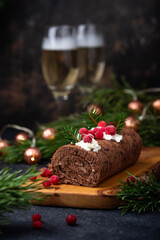 Fototapeta na wymiar Christmas chocolate roll cake with cream