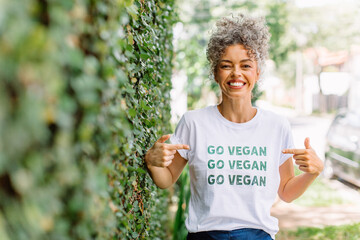 Happy vegan activist advocating for veganism outdoors - obrazy, fototapety, plakaty