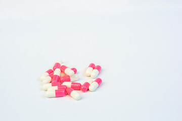 red and white pills capsule in white background