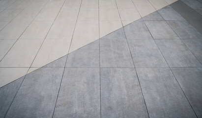 Two color tones floor design. The flooring is made of matte ceramic tiles.