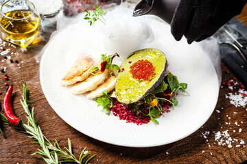 Tuna tartare. Trout roe, avocado cream, marinated onions. Delicious healthy Italian traditional food closeup served for lunch in modern gourmet cuisine restaurant