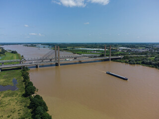 Martinus Nijhoff bridge over the river Waal in the Netherlands, flooded land and ship on river