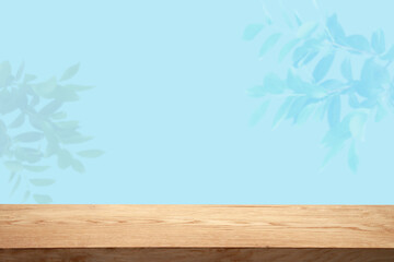 Empty table top made of natural wood, illuminated wall. For product demonstration and installation