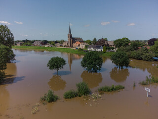 Fototapeta premium Flooded land and floodplains, drowned trees, river Maas village Appeltern