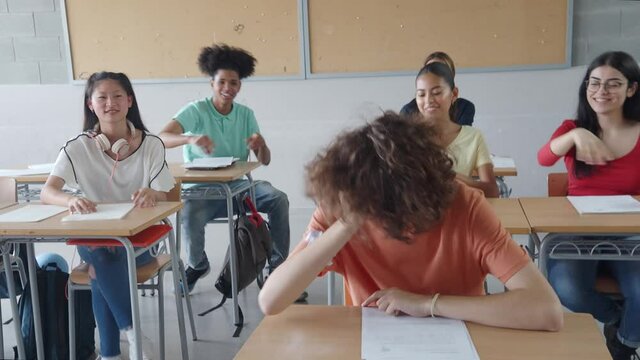 Multiethnic teenage students in class bullying a student. Bullying 