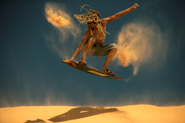 Kitesurf freestyle in sanddunes at sunset. © Oleg