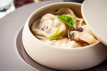 Black Angus beef hand-made dumplings. Cucumber-julienne with chilli-garlic butter and sour cream. Delicious healthy traditional food closeup served for lunch in modern gourmet cuisine restaurant